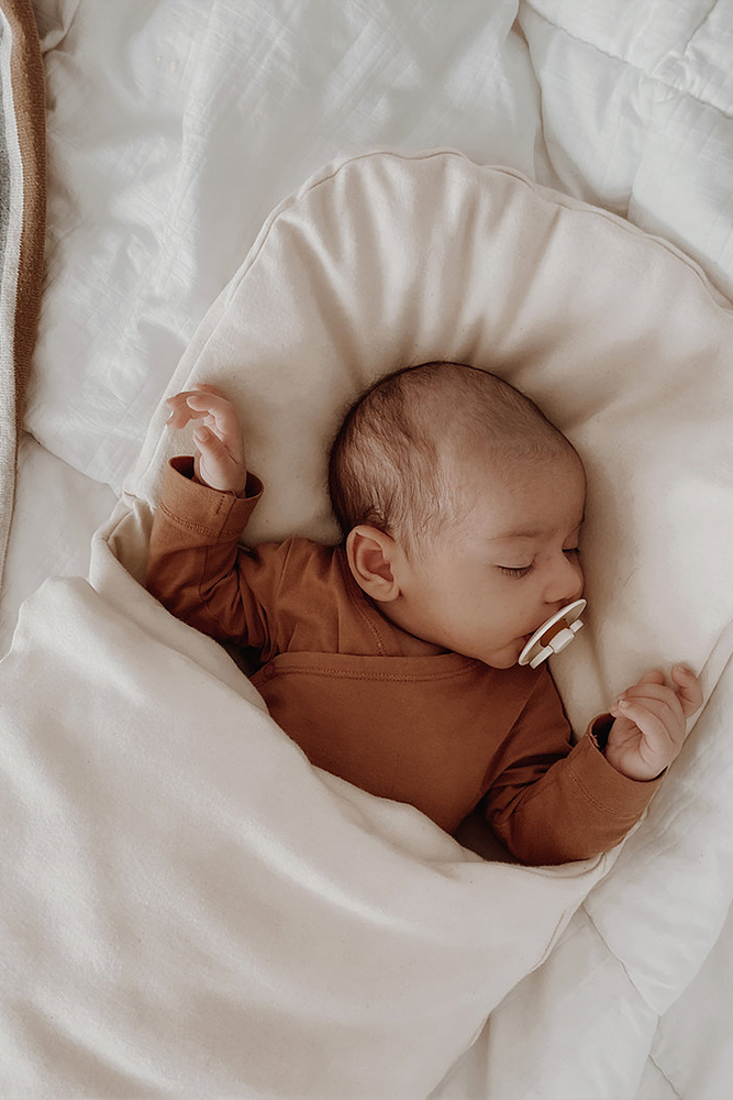 Baby sleeping in Bundl wool wrap 