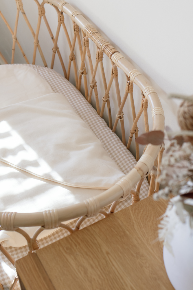 plain wool wrap in rattan bassinet